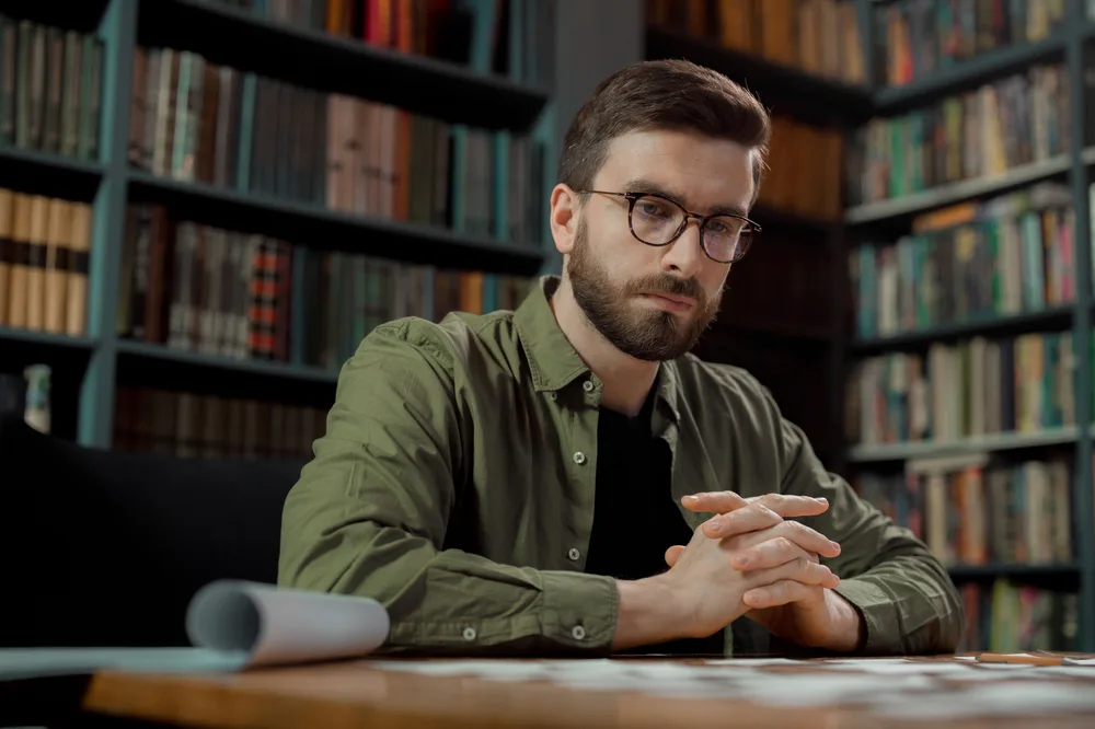 A scholar in a quiet library, warm light